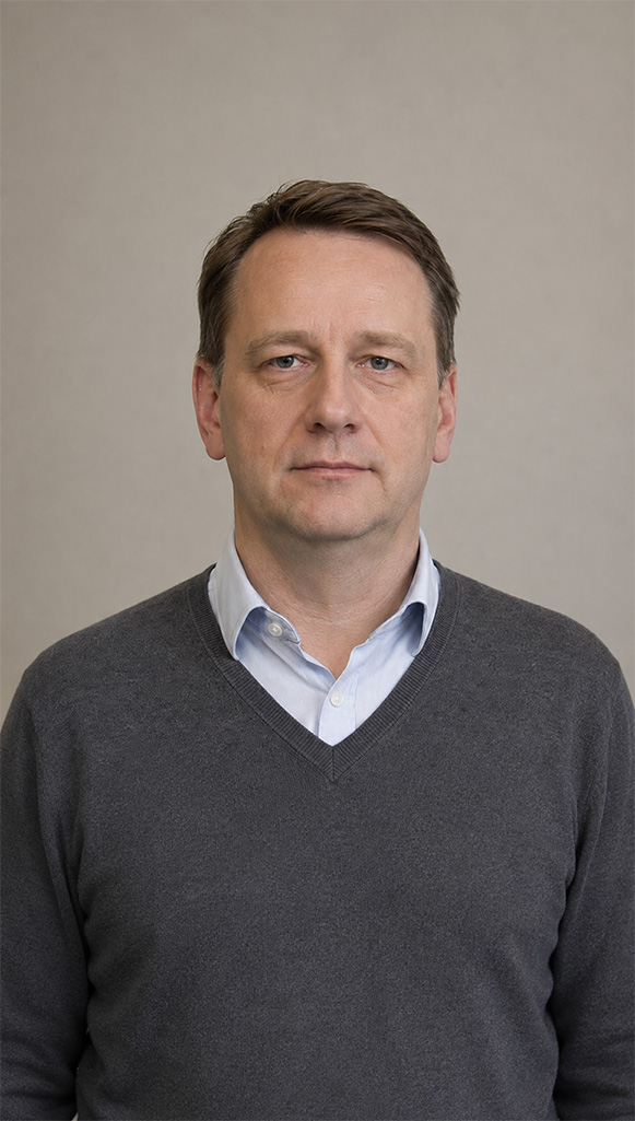 Langweiliges Headshot-Portrait eines Mannes vor grauem Hintergrund als Beispiel für austauschbare Unternehmensfotos